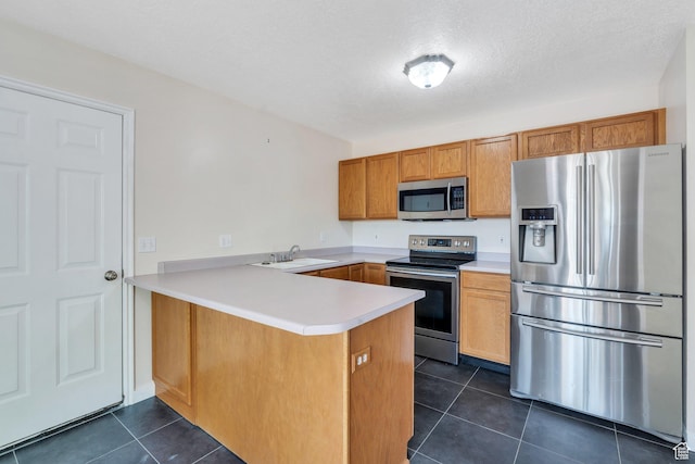 5144 W Wheatcrest Cir, West Jordan, UT 84081 - kitchen featuring stainless steel appliances, a peninsula, dark tile patterned floors, light countertops, and a sink