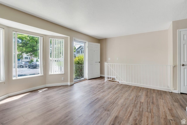 5144 W Wheatcrest Cir, West Jordan, UT 84081 - empty room featuring wood finished floors, healthy amount of natural light, and baseboards