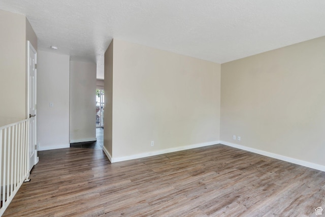 5144 W Wheatcrest Cir, West Jordan, UT 84081 - spare room featuring wood finished floors and baseboards