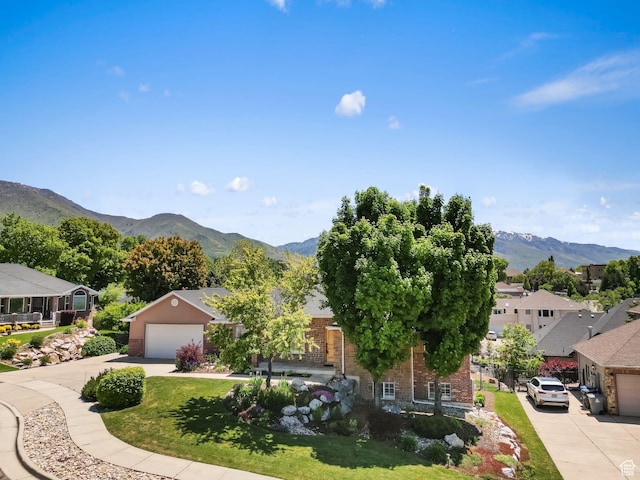 1291 E 5630 S, South Ogden, UT 84403 - view of front facade with brick siding, driveway, a garage, and a mountain view