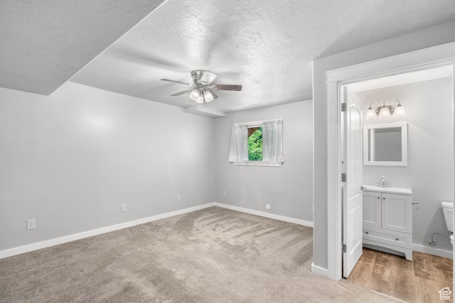 1291 E 5630 S, South Ogden, UT 84403 - unfurnished bedroom with baseboards, a textured ceiling, light carpet, ensuite bathroom, and ceiling fan