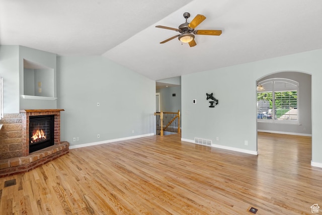 1291 E 5630 S, South Ogden, UT 84403 - unfurnished living room with light wood finished floors, a brick fireplace, a ceiling fan, lofted ceiling, and baseboards