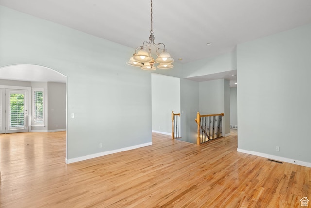 1291 E 5630 S, South Ogden, UT 84403 - empty room featuring arched walkways, a chandelier, light wood-type flooring, and baseboards