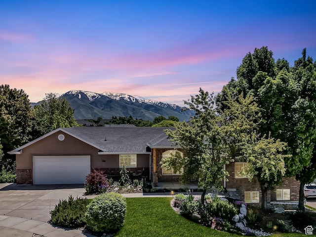 1291 E 5630 S, South Ogden, UT 84403 - view of front of house with brick siding, driveway, a garage, a mountain view, and stucco siding