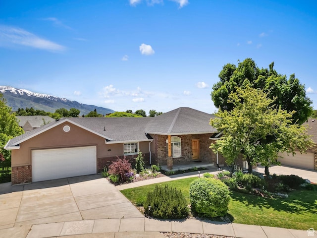 1291 E 5630 S, South Ogden, UT 84403 - ranch-style house featuring brick siding, an attached garage, driveway, a mountain view, and a front lawn