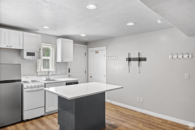 1291 E 5630 S, South Ogden, UT 84403 - kitchen featuring white appliances, a sink, light countertops, a kitchen island, and a textured ceiling