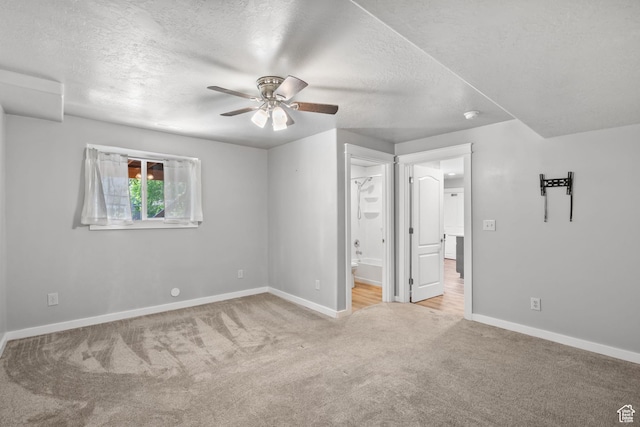 1291 E 5630 S, South Ogden, UT 84403 - unfurnished bedroom with carpet flooring, a textured ceiling, baseboards, ensuite bath, and ceiling fan