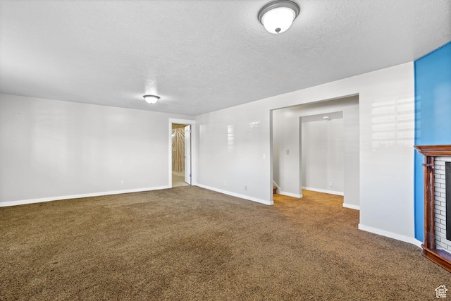 1291 E 5630 S, South Ogden, UT 84403 - carpeted empty room featuring a textured ceiling, baseboards, and a brick fireplace
