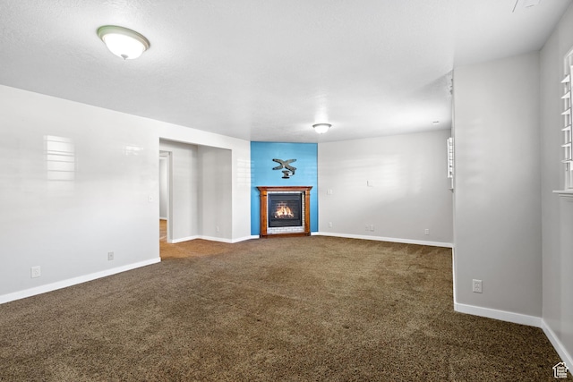 1291 E 5630 S, South Ogden, UT 84403 - unfurnished living room with a lit fireplace, dark colored carpet, and baseboards