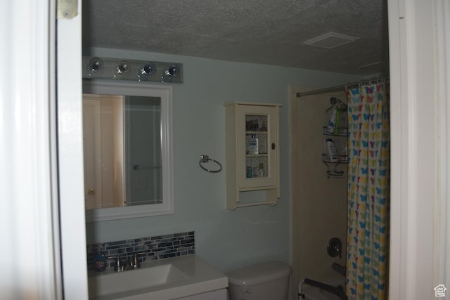 963 W Rainbow Dr, Logan, UT 84321 - full bath with vanity, toilet, a textured ceiling, shower / bathtub combination with curtain, and decorative backsplash