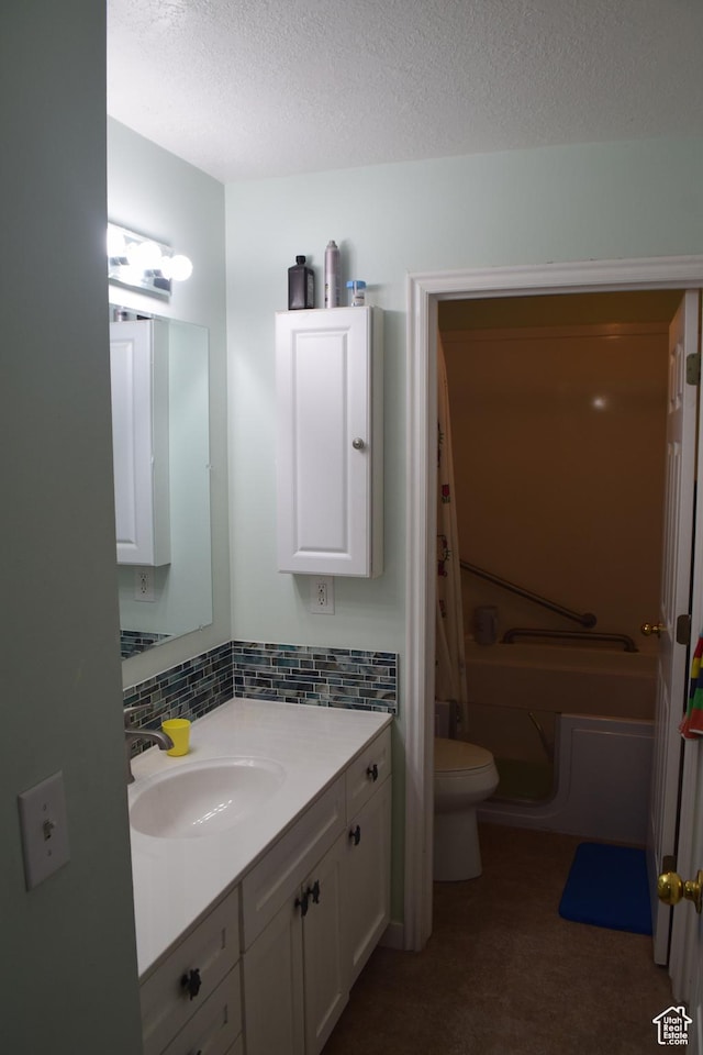 963 W Rainbow Dr, Logan, UT 84321 - full bath with vanity, toilet, a tub to relax in, a textured ceiling, and tasteful backsplash