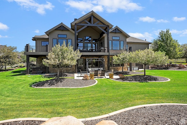 3858 E Eagle Ct, Eden, UT 84310 - rear view of house with a balcony, a patio area, and a lawn