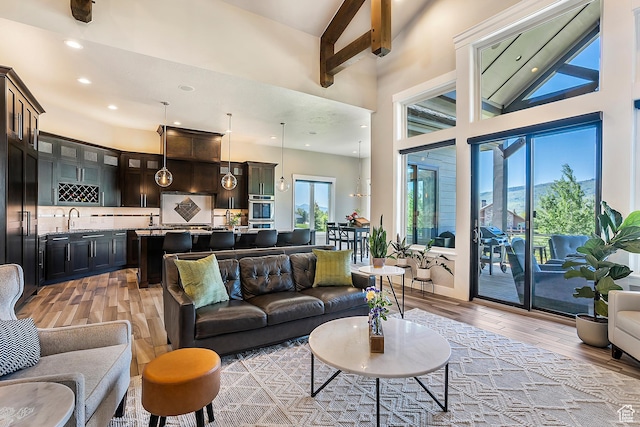 3858 E Eagle Ct, Eden, UT 84310 - living room featuring light wood-type flooring, a towering ceiling, and recessed lighting