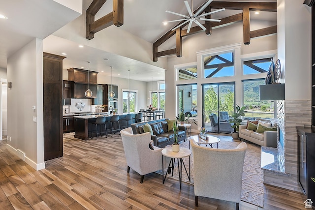 3858 E Eagle Ct, Eden, UT 84310 - living room with high vaulted ceiling, wood finished floors, beamed ceiling, baseboards, and recessed lighting