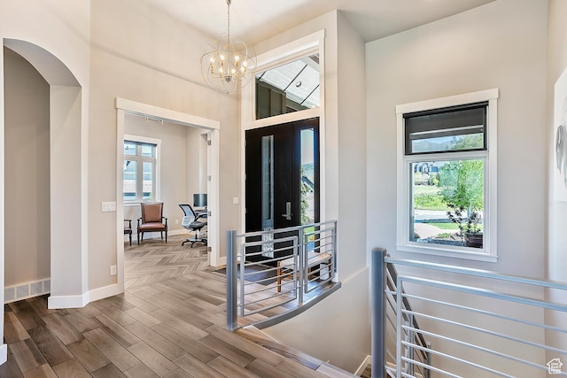 3858 E Eagle Ct, Eden, UT 84310 - entryway featuring wood finished floors, baseboards, a chandelier, and arched walkways