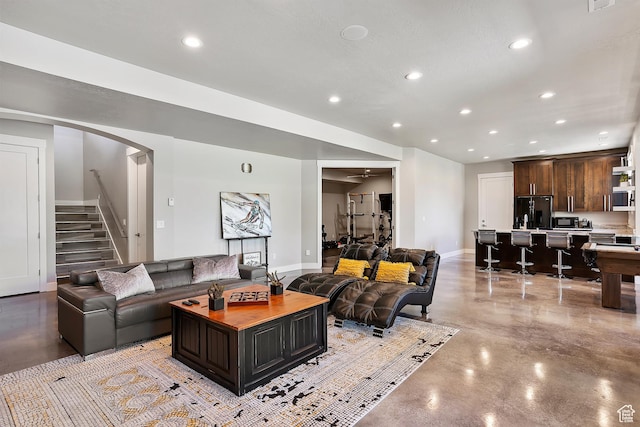 3858 E Eagle Ct, Eden, UT 84310 - living room with finished concrete floors, recessed lighting, stairs, baseboards, and arched walkways