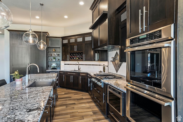 3858 E Eagle Ct, Eden, UT 84310 - kitchen featuring a sink, appliances with stainless steel finishes, open shelves, wood finished floors, and dark brown cabinetry