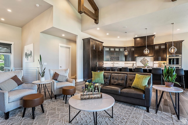 3858 E Eagle Ct, Eden, UT 84310 - living room featuring recessed lighting, a high ceiling, wood finished floors, and baseboards