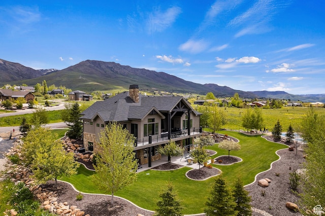 3858 E Eagle Ct, Eden, UT 84310 - back of house with a patio, a balcony, a chimney, a yard, and a mountain view