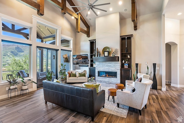 3858 E Eagle Ct, Eden, UT 84310 - living area featuring high vaulted ceiling, a fireplace, wood finished floors, arched walkways, and baseboards
