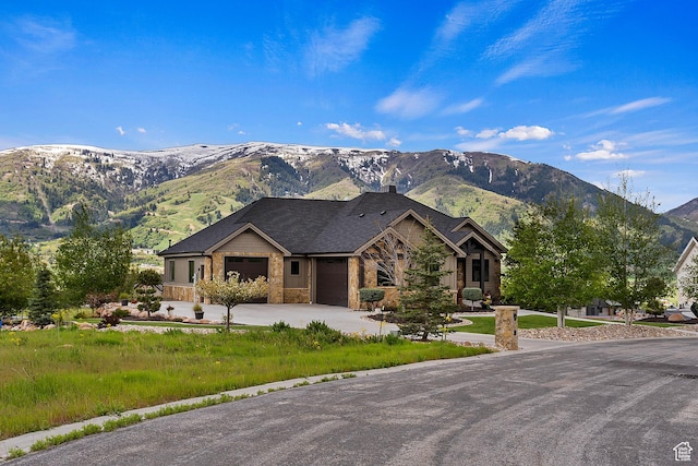 3858 E Eagle Ct, Eden, UT 84310 - view of front of home with a mountain view, an attached garage, driveway, a chimney, and stone siding