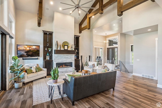 3858 E Eagle Ct, Eden, UT 84310 - living room with high vaulted ceiling, a stone fireplace, beamed ceiling, wood finished floors, and baseboards