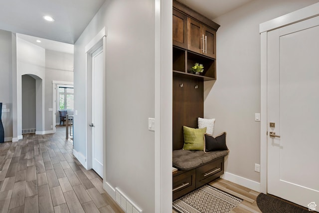 3858 E Eagle Ct, Eden, UT 84310 - mudroom featuring arched walkways, light wood-style flooring, recessed lighting, and baseboards