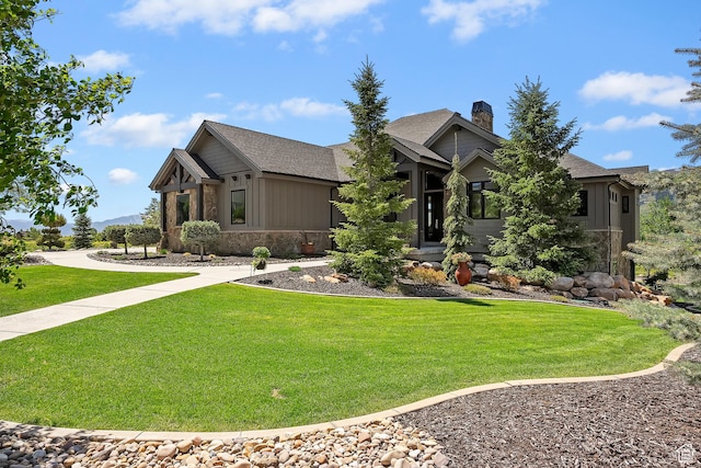 3858 E Eagle Ct, Eden, UT 84310 - craftsman inspired home featuring stone siding, a front lawn, board and batten siding, and a chimney