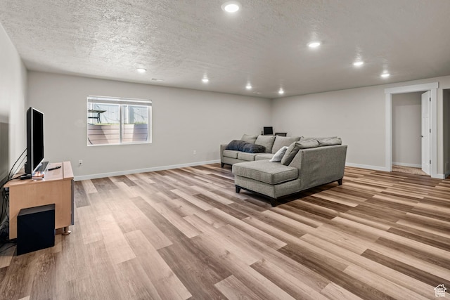 3932 S Sennie Dr W, Magna, UT 84044 - living area with light wood finished floors, recessed lighting, baseboards, and a textured ceiling