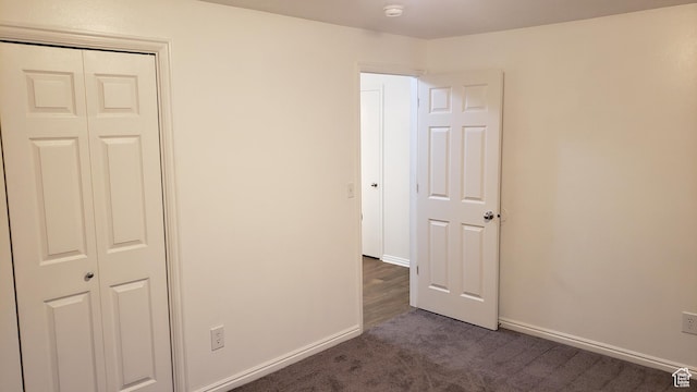 125 W 870 N, Orem, UT 84057 - unfurnished bedroom featuring dark colored carpet, baseboards, and a closet