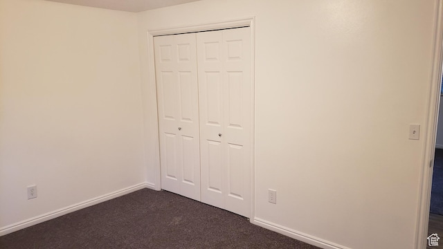 125 W 870 N, Orem, UT 84057 - unfurnished bedroom featuring dark carpet, baseboards, and a closet