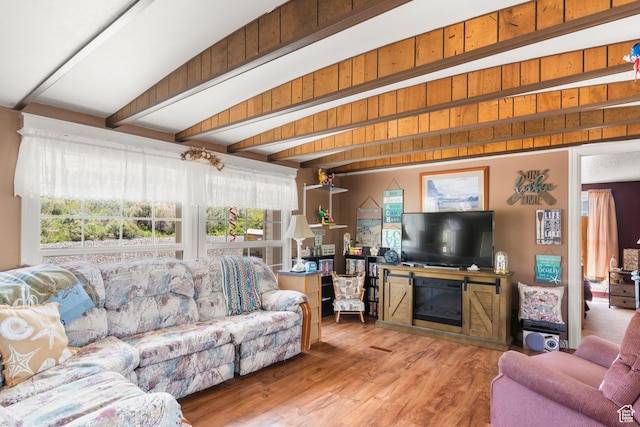 3058 S Edgemont Dr Unit 253, 54, Garden City, UT 84028 - living room featuring beamed ceiling, healthy amount of natural light, wood finished floors, and a glass covered fireplace