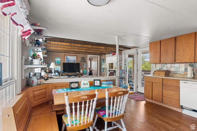 3058 S Edgemont Dr Unit 253, 54, Garden City, UT 84028 - kitchen with dishwasher, light countertops, light wood finished floors, decorative backsplash, and brown cabinets