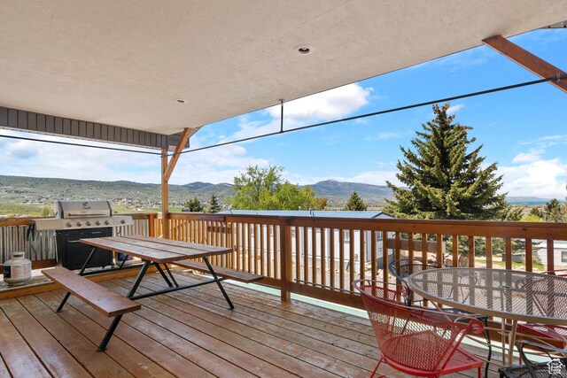 3058 S Edgemont Dr Unit 253, 54, Garden City, UT 84028 - wooden deck featuring outdoor dining space, a mountain view, and grilling area