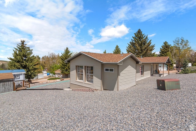 3058 S Edgemont Dr Unit 253, 54, Garden City, UT 84028 - view of side of home with roof with shingles