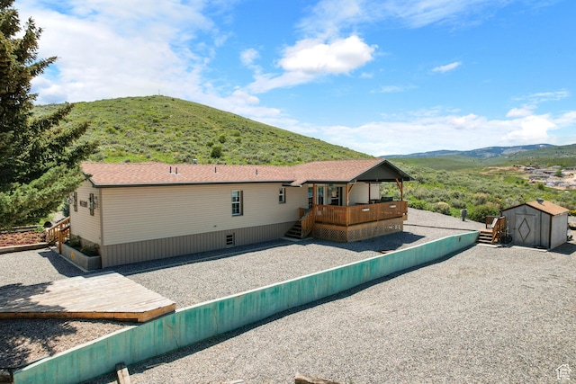 3058 S Edgemont Dr Unit 253, 54, Garden City, UT 84028 - rear view of house featuring a deck with mountain view