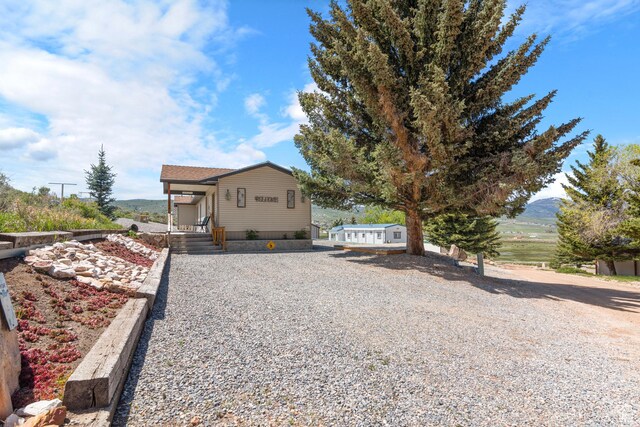 3058 S Edgemont Dr Unit 253, 54, Garden City, UT 84028 - view of front facade featuring gravel driveway and a mountain view