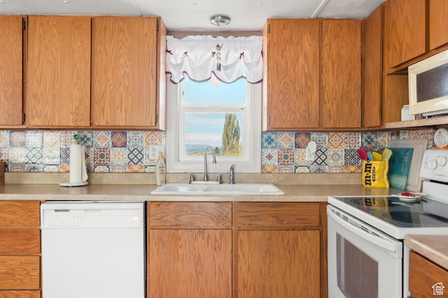 3058 S Edgemont Dr Unit 253, 54, Garden City, UT 84028 - kitchen with white appliances, a sink, light countertops, and decorative backsplash