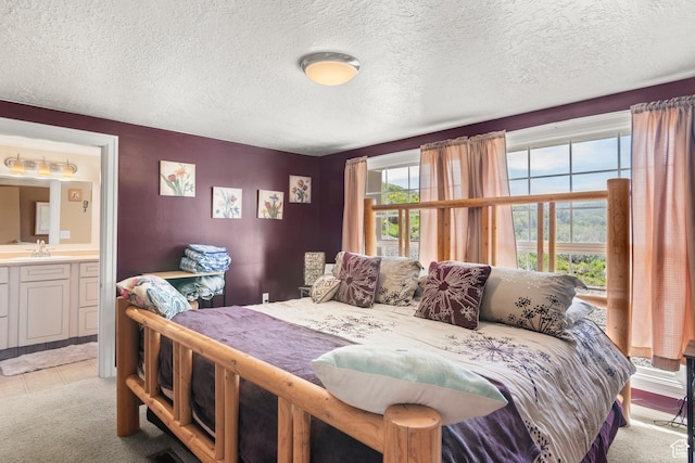 3058 S Edgemont Dr Unit 253, 54, Garden City, UT 84028 - bedroom with a sink, a textured ceiling, light carpet, and ensuite bath