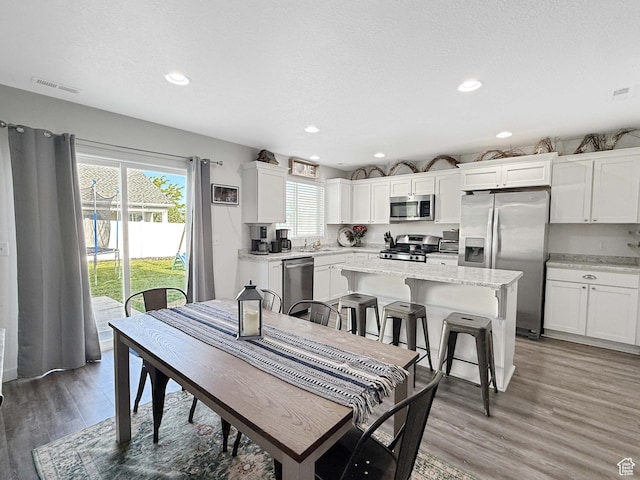 3508 S Creek Side Ln, Syracuse, UT 84075 - dining room featuring light wood-style flooring and recessed lighting