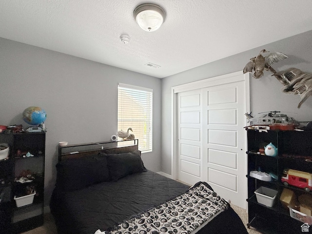 3508 S Creek Side Ln, Syracuse, UT 84075 - bedroom with carpet, a closet, and a textured ceiling
