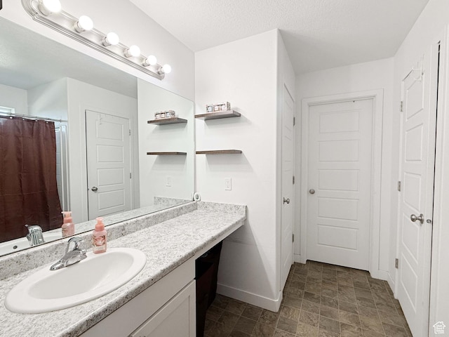 3508 S Creek Side Ln, Syracuse, UT 84075 - bathroom with baseboards, vanity, stone finish floors, and curtained shower