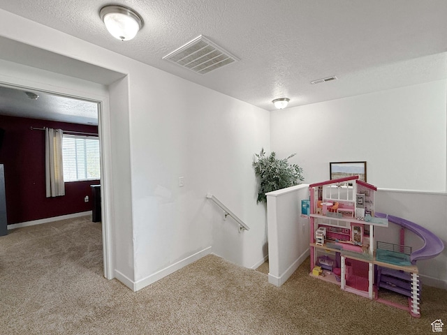 3508 S Creek Side Ln, Syracuse, UT 84075 - recreation room with a textured ceiling, carpet flooring, and baseboards