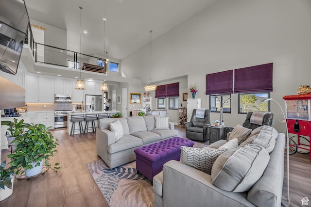 9984 N Rail Loop Unit 29, Heber City, UT 84032 - living area featuring light wood-style floors and a high ceiling