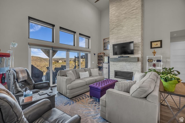 9984 N Rail Loop Unit 29, Heber City, UT 84032 - living area featuring a high ceiling, a stone fireplace, and wood finished floors