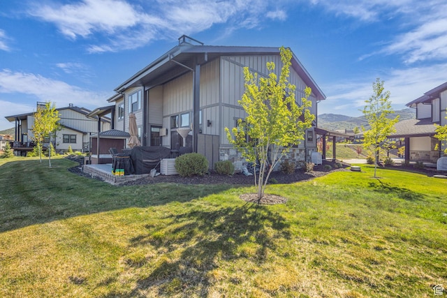 9984 N Rail Loop Unit 29, Heber City, UT 84032 - view of side of home featuring a yard, a mountain view, board and batten siding, and stone siding