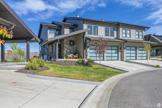 9984 N Rail Loop Unit 29, Heber City, UT 84032 - view of front of home featuring stone siding, board and batten siding, driveway, an attached garage, and a front yard