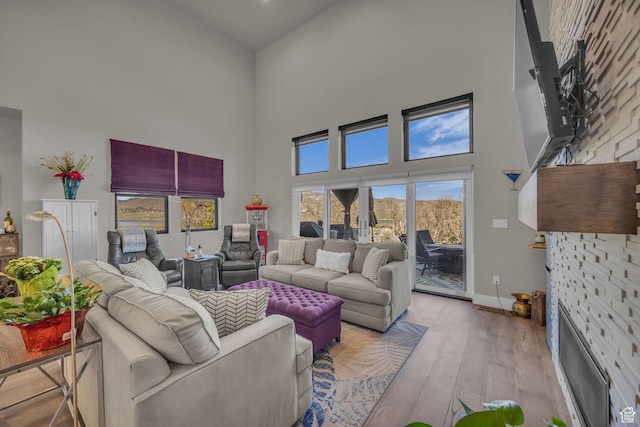 9984 N Rail Loop Unit 29, Heber City, UT 84032 - living room with a towering ceiling, wood finished floors, and baseboards