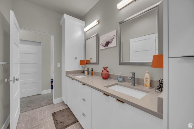 9984 N Rail Loop Unit 29, Heber City, UT 84032 - bathroom featuring double vanity, baseboards, and brick patterned floors