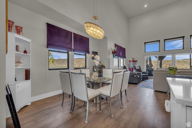 9984 N Rail Loop Unit 29, Heber City, UT 84032 - dining room with a chandelier, a high ceiling, plenty of natural light, wood finished floors, and baseboards